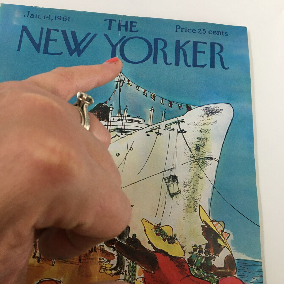 Close-up of The New Yorker magazine cover dated January 14, 1961, showing a hand pointing at the title, highlighting its vibrant illustration of a cruise ship.