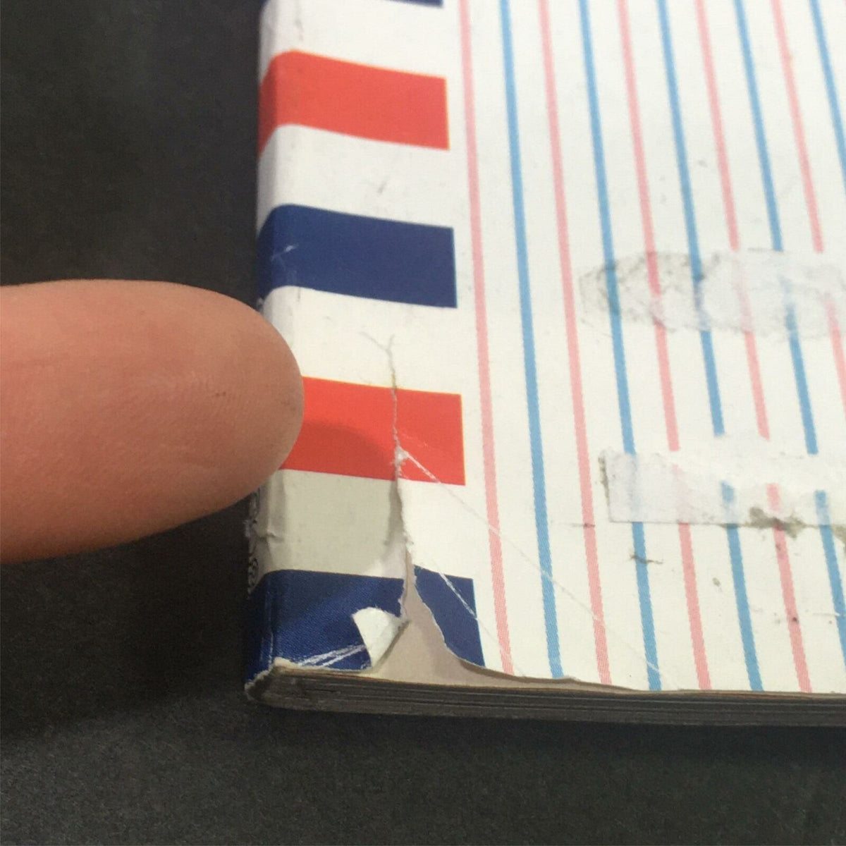 Detail of the spine of The New Yorker October 13 2008 magazine, highlighting minor wear with a small rip, an informative piece for collectors interested in vintage magazines.