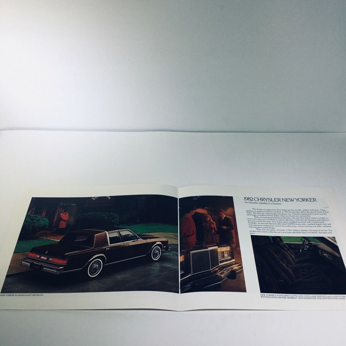 Inside view of the 1982 Chrysler New Yorker V-8 OHV 6-cyl OHV 8/81 Car Sale Brochure displaying the rear of the car parked in an elegant setting.