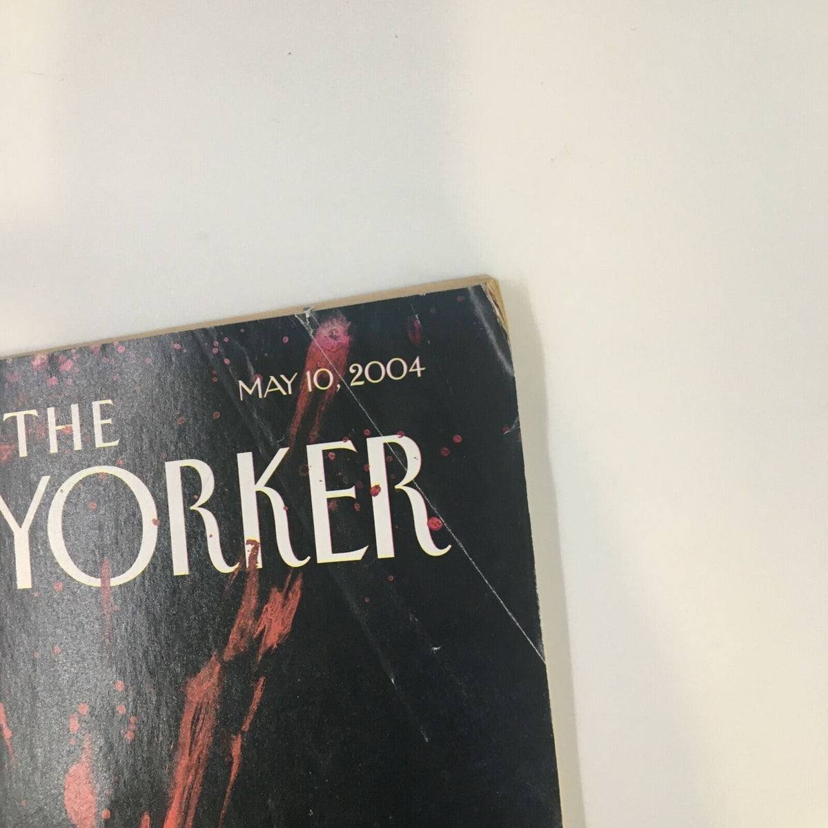 Detailed shot of the corner of The New Yorker magazine May 10, 2004, showing the date and part of the cover art 'Open Wound' by Ana Juan, highlighting the magazine's vintage quality.