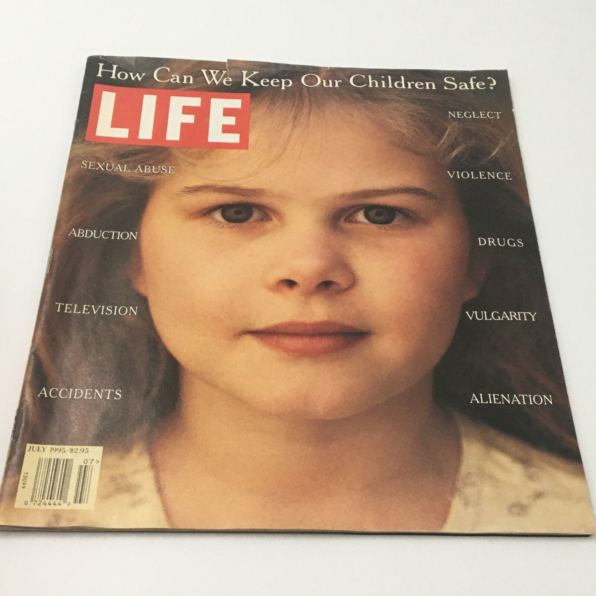 Another angle of the Life Magazine cover from July 1995, depicting the title 'How Can We Keep Our Children Safe?' with a focus on a young girl's face, listing child safety topics like drugs, vulgarity, and accidents.