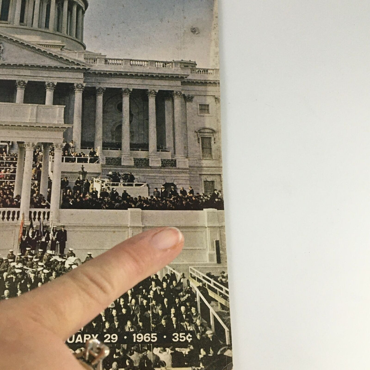 Close-up of the side of the VTG Life Magazine January 29 1965 cover, highlighting the date and price with finger pointing.