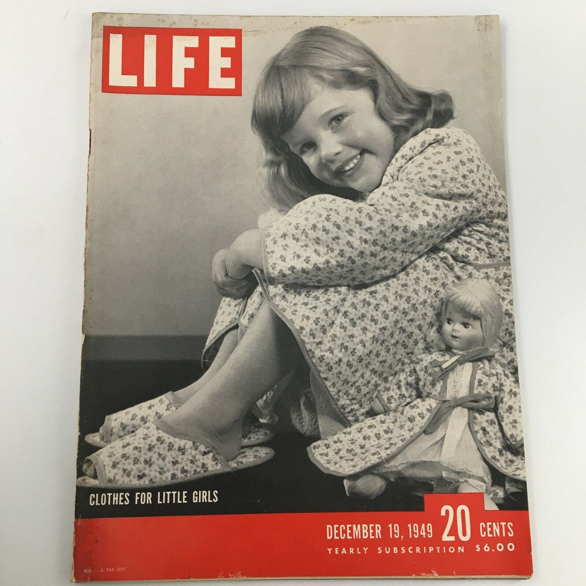 Cover of VTG Life Magazine from December 19, 1949 featuring a young girl with a doll wearing floral dress, titled 'Clothes for Little Girls'.