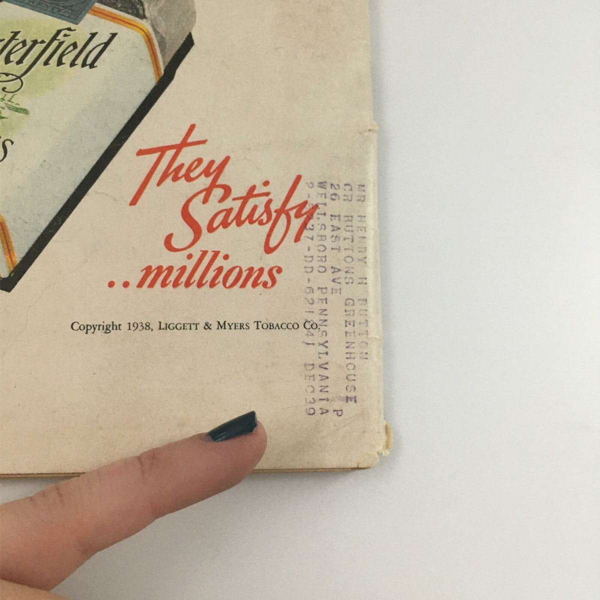 Close-up of the Chesterfield cigarette advertisement from 1938, highlighting the tagline 'They Satisfy millions' with vintage graphics.