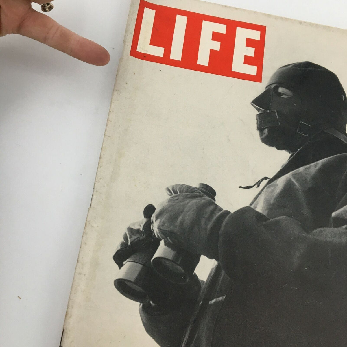 Close-up of the cover of VTG Life Magazine January 19 1942, highlighting the title Life and a man in a mask holding binoculars.