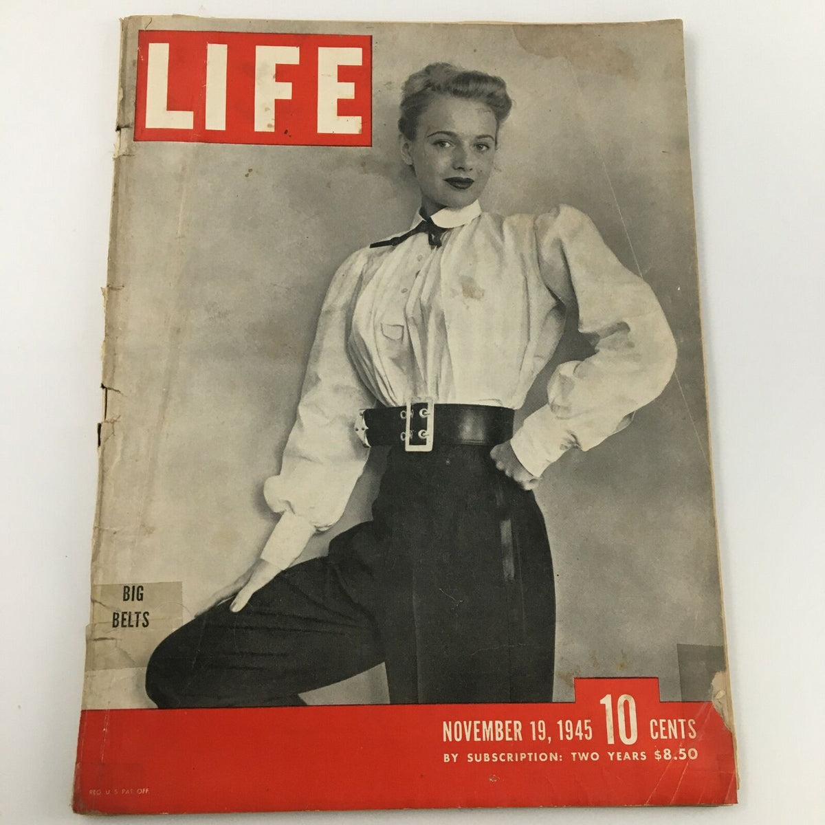 Vintage Life Magazine cover from November 19, 1945, featuring a model showcasing the 'Big Belts' fashion, reflecting post-war style.