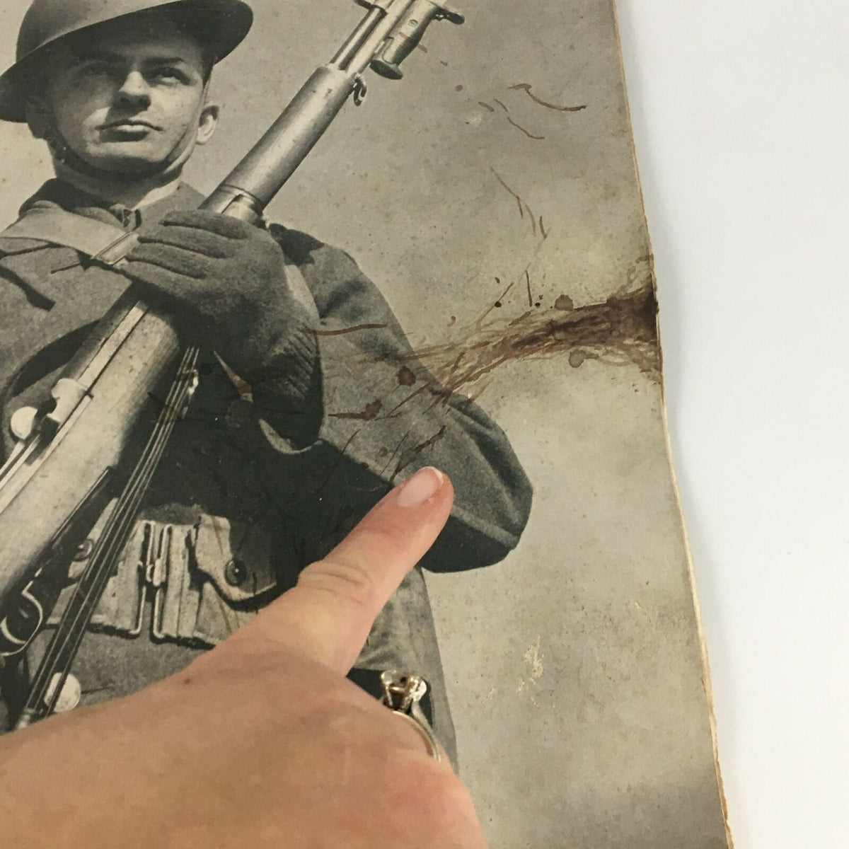 Close-up of vintage Life Magazine featuring Private Charles Teed on the cover, with focus on damage to the image showing age wear.