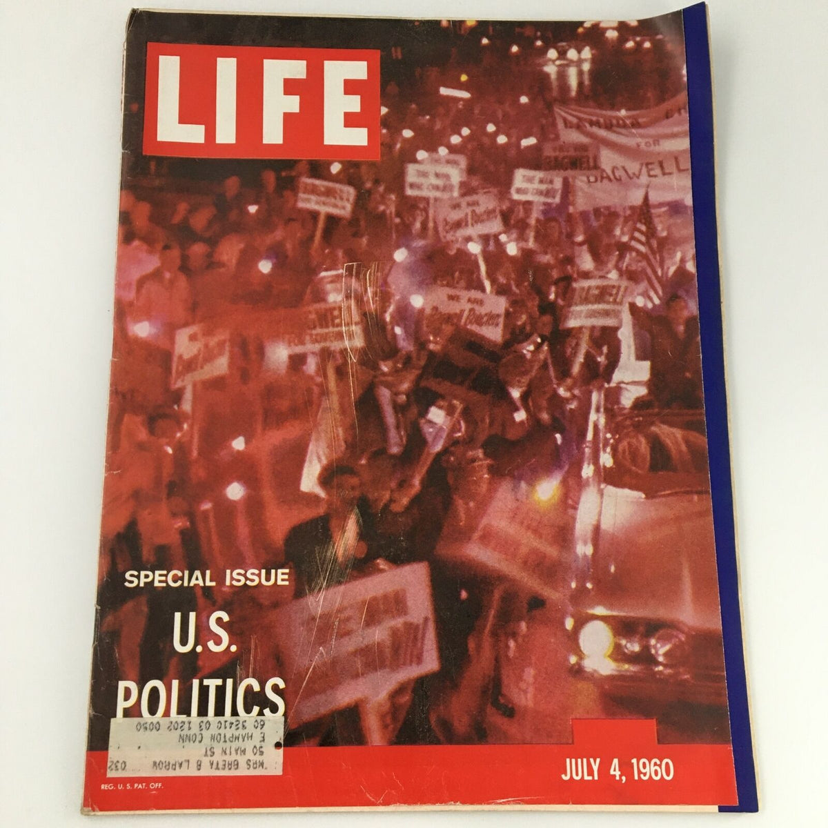 Cover of VTG Life Magazine July 4, 1960 featuring a special issue on U.S. Politics with a vibrant crowd holding signs in support of various causes, symbolizing the political climate of the era.