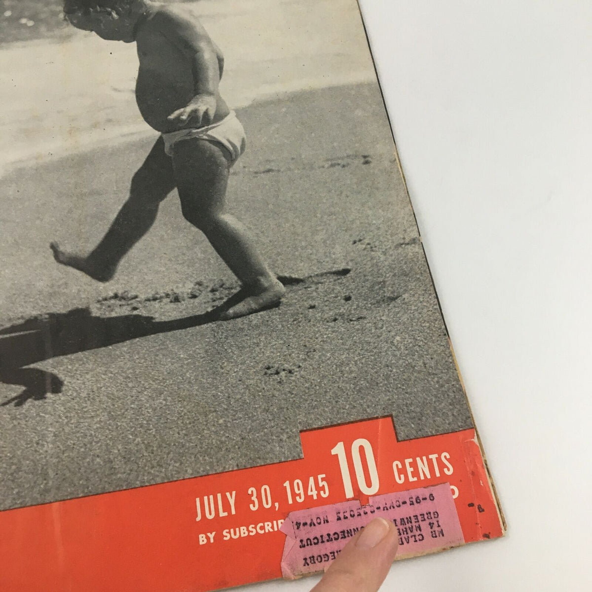 Close-up of the cover of VTG Life Magazine July 30 1945, showing a child's foot in the sand and the magazine price of 10 cents, titled 'Playing With Shadows On The Shore.'