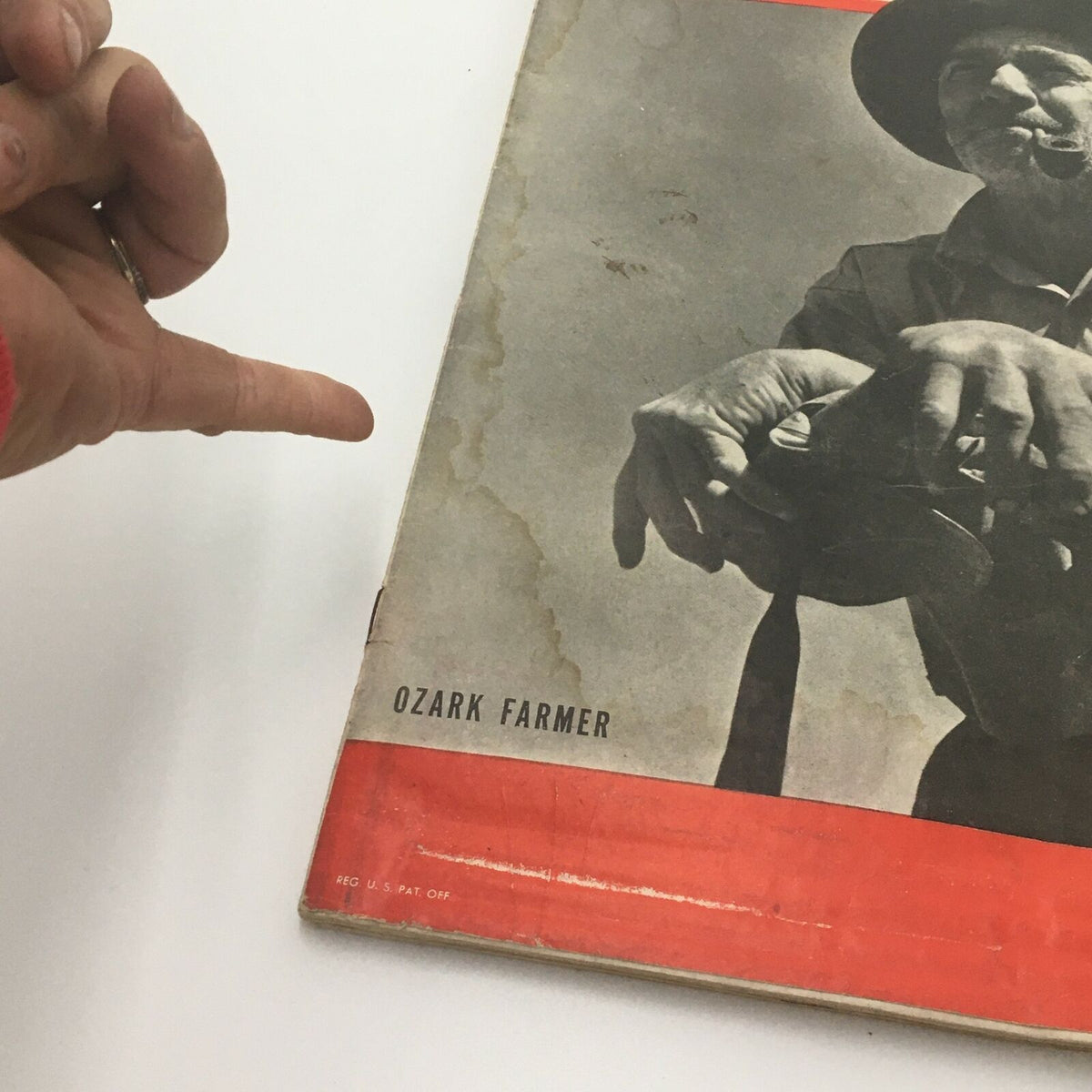 Close-up view of the Vintage Life Magazine May 27 1946 Ozark Farmer Cover, highlighting the farmer's hands holding a vintage item, with visible wear characteristic of a used magazine.