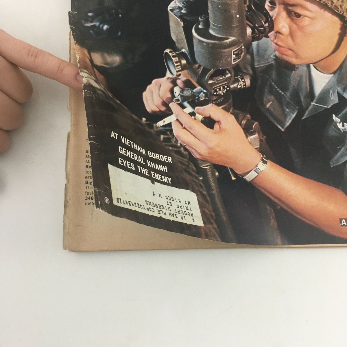Close-up view of the VTG Life Magazine Cover August 21 1964 with visible wear, highlighting the text 'At Vietnam Border, General Kahn, Eyes the Enemy'.