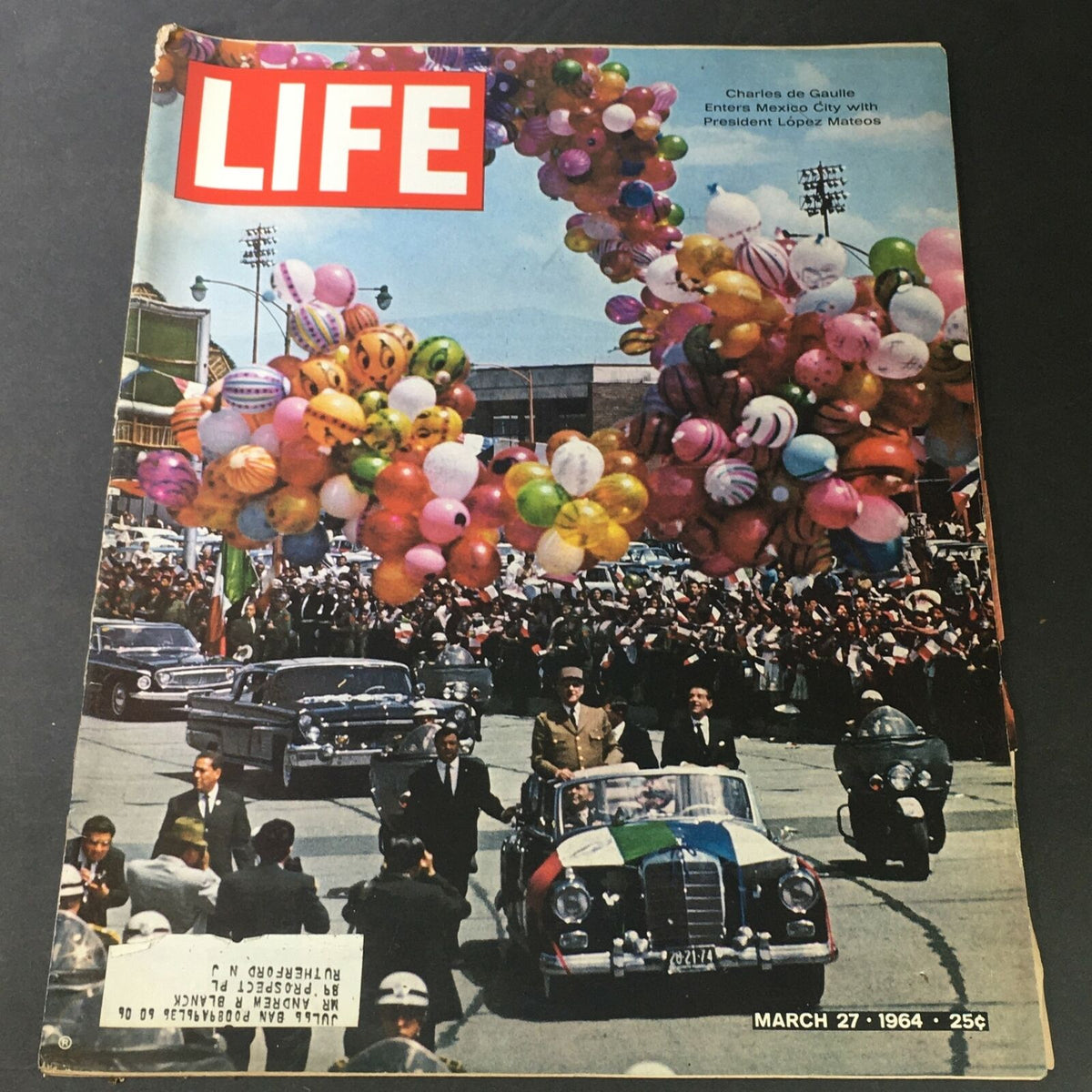 Cover of VTG Life Magazine March 27, 1964 showcasing a parade with Charles de Gaulle and President Lopez Mateos, colorful balloons, and crowds celebrating in Mexico City.