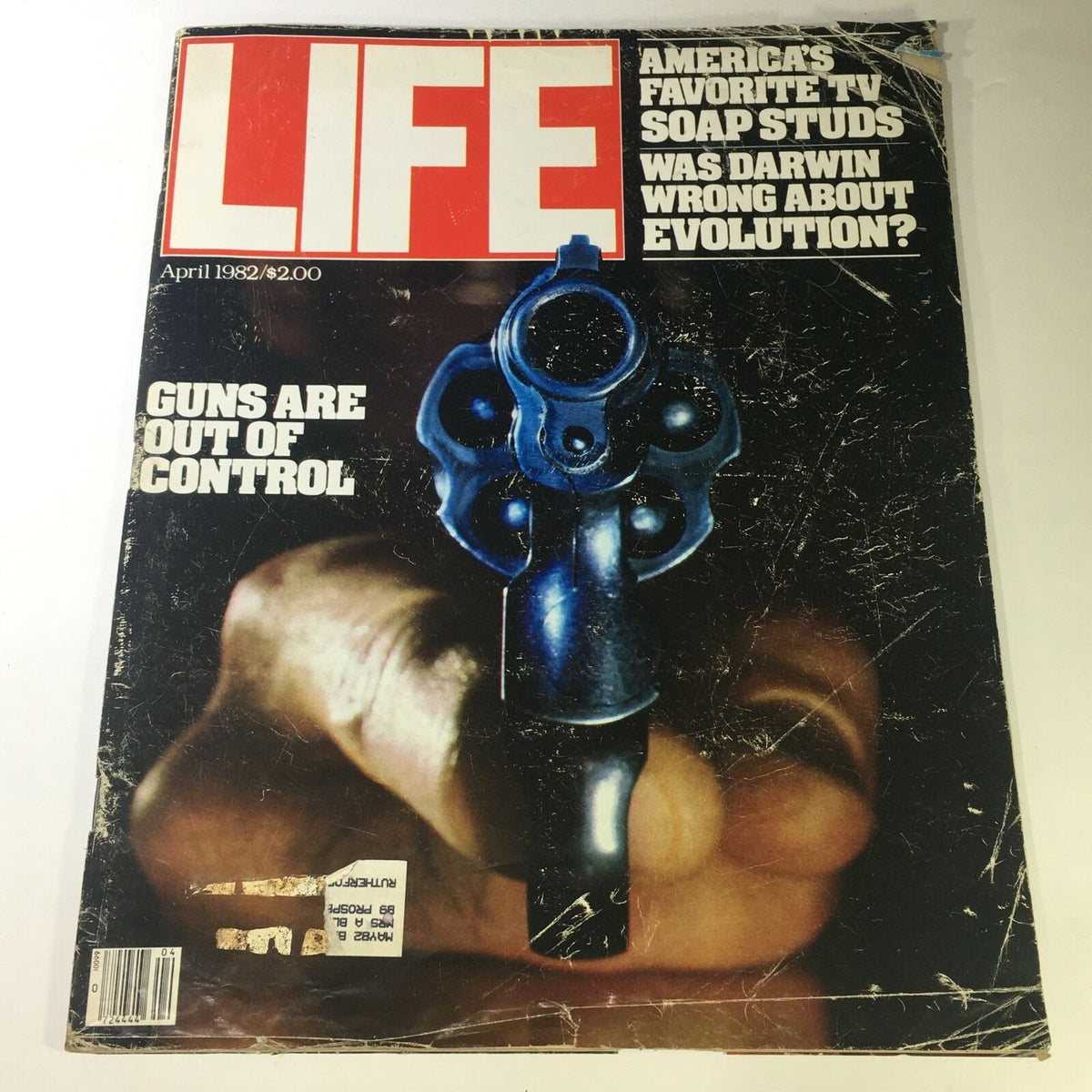 VTG Life Magazine April 1982 cover featuring the headline 'Guns Are Out of Control' and a striking image of a blue revolver, alongside a discussion on Darwin and evolution.