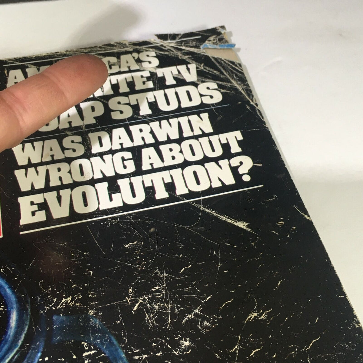 Top view of wear on the cover of VTG Life Magazine April 1982 showcasing the title regarding Darwin and evolution.