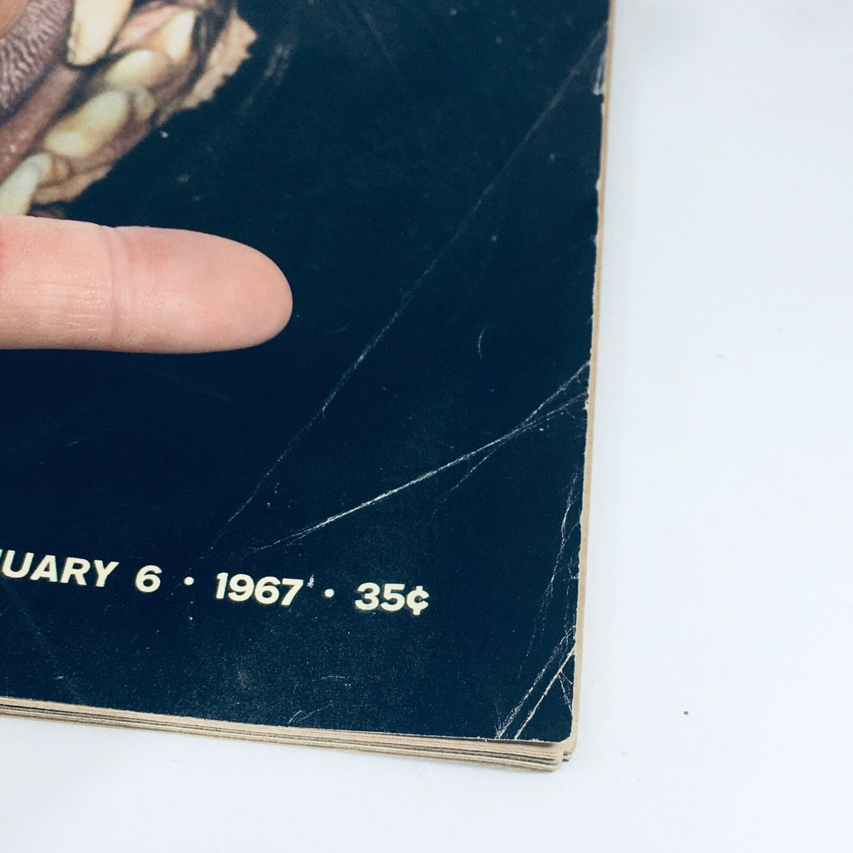 Close-up view of the VTG Life Magazine from January 6, 1967. The image highlights the date and price on the bottom corner, with a finger pointing to the magazine's details.