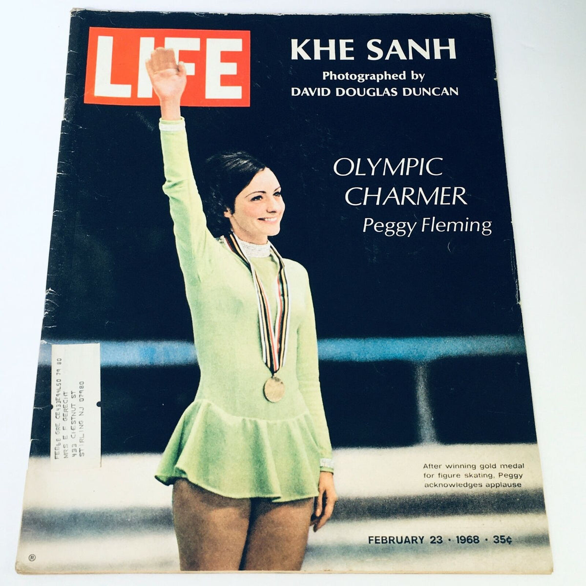 Cover of VTG Life Magazine from February 23, 1968 featuring Khe Sanh and Olympic charmer Peggy Fleming, showcasing imagery of a medal-winning figure skater and highlighting historical moments from the Vietnam War.