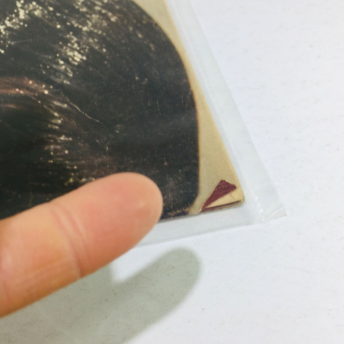 Close-up view of the corner of the VTG Life Magazine from August 18, 1972, showcasing the wear on the cover with a finger pointing at a red triangular image detail related to the preview of the Munich Surge to the Olympics.