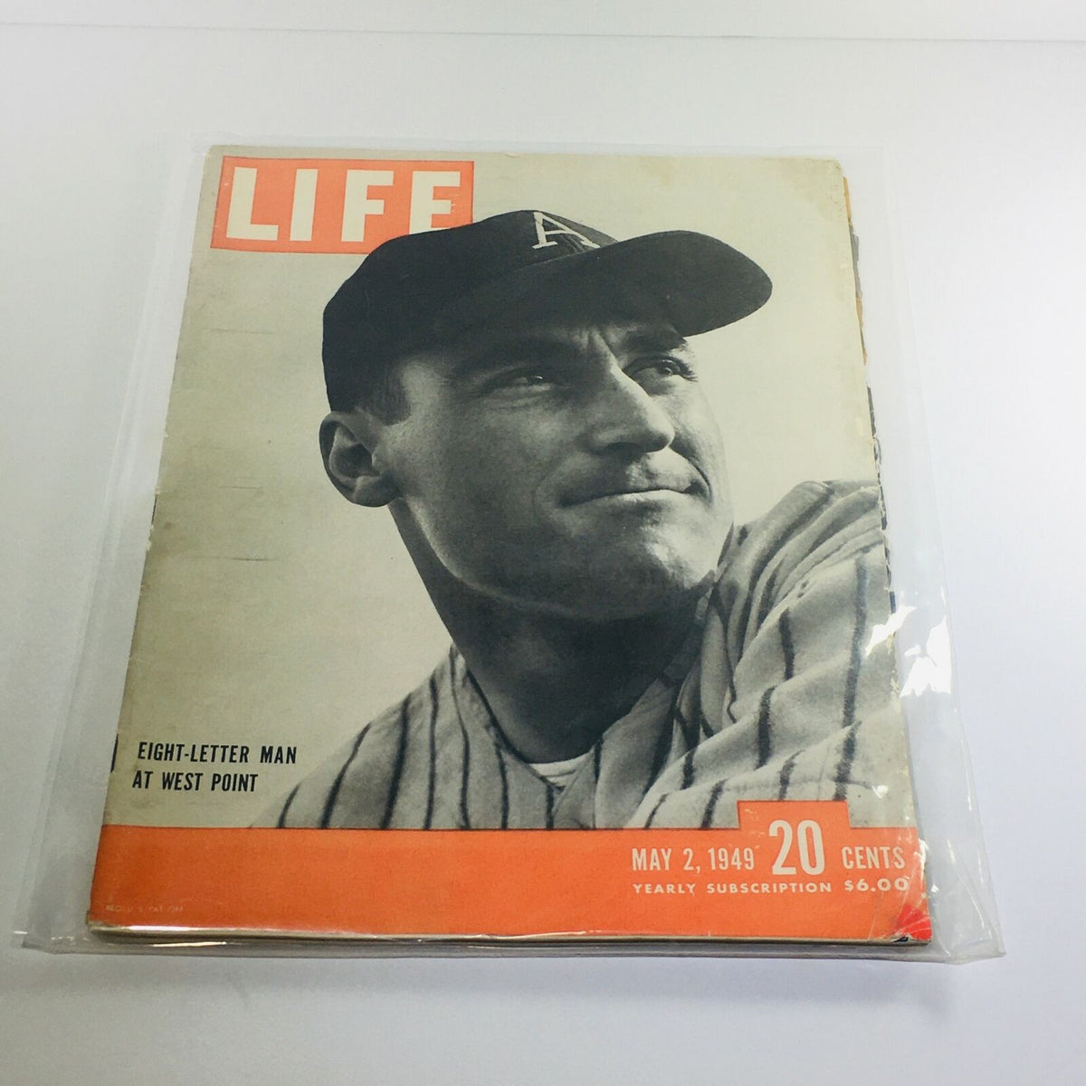 Vintage Life Magazine cover from May 2, 1949, featuring the title 'Eight-Letter Man at West Point: Arnold Galiffa.' The cover showcases a historical portrait of a man in a baseball cap, encapsulating the essence of post-World War II America.