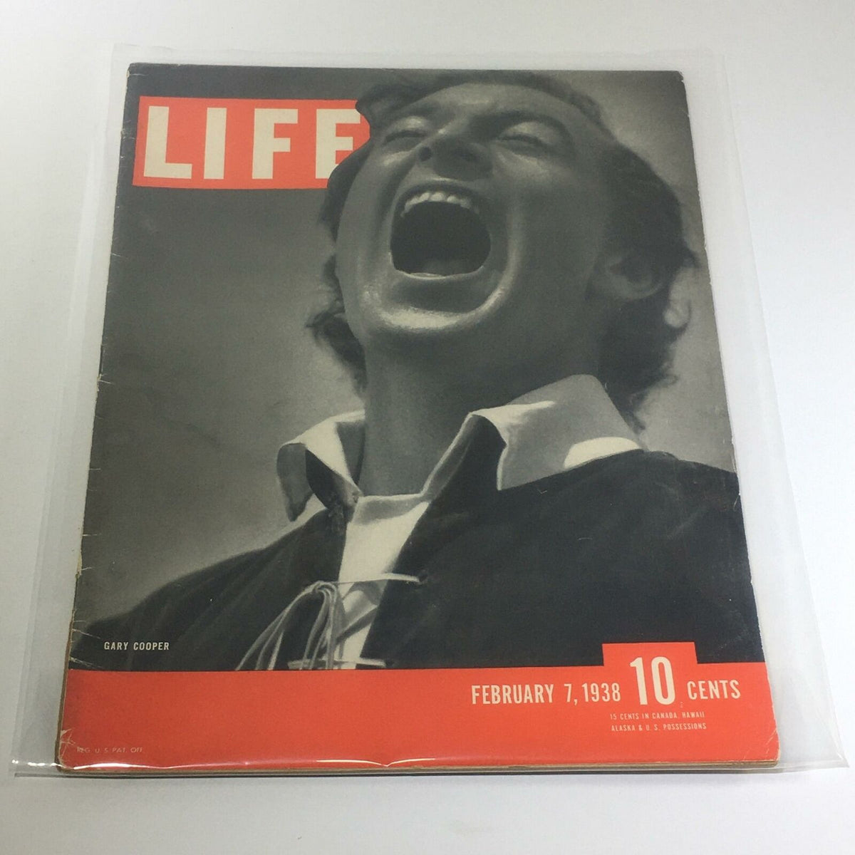Vintage Life Magazine Cover featuring Gary Cooper from February 7, 1938, showcasing a captivating black and white image with vibrant red titling.