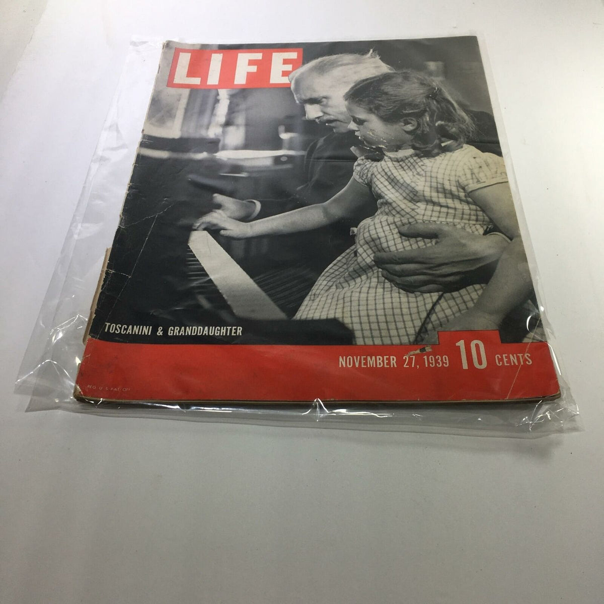 Vintage Life Magazine from November 27, 1939, featuring renowned conductor Arturo Toscanini with his granddaughter, highlighting a nostalgic moment in history.