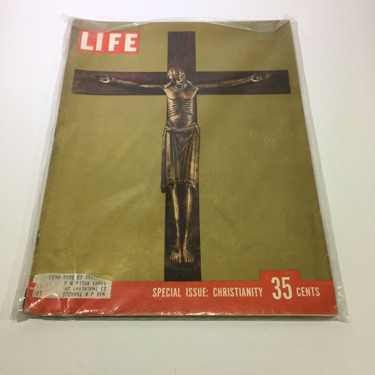 VTG Life Magazine December 26 1955 - Special Issue About Christianity featuring a striking cover illustration with a crucifix. The magazine is encased in protective plastic to maintain its vintage condition.