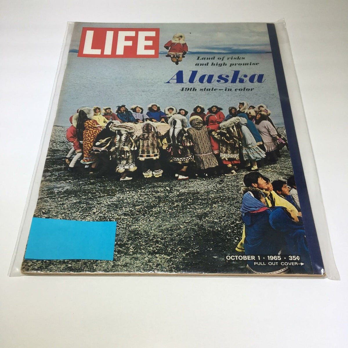 Vintage Life Magazine cover from October 1, 1965, featuring the title 'High Promise Alaska, The 49th State - In Color'. The image showcases a group of people in traditional attire gathered on a rocky landscape, highlighting Alaska's cultural heritage.