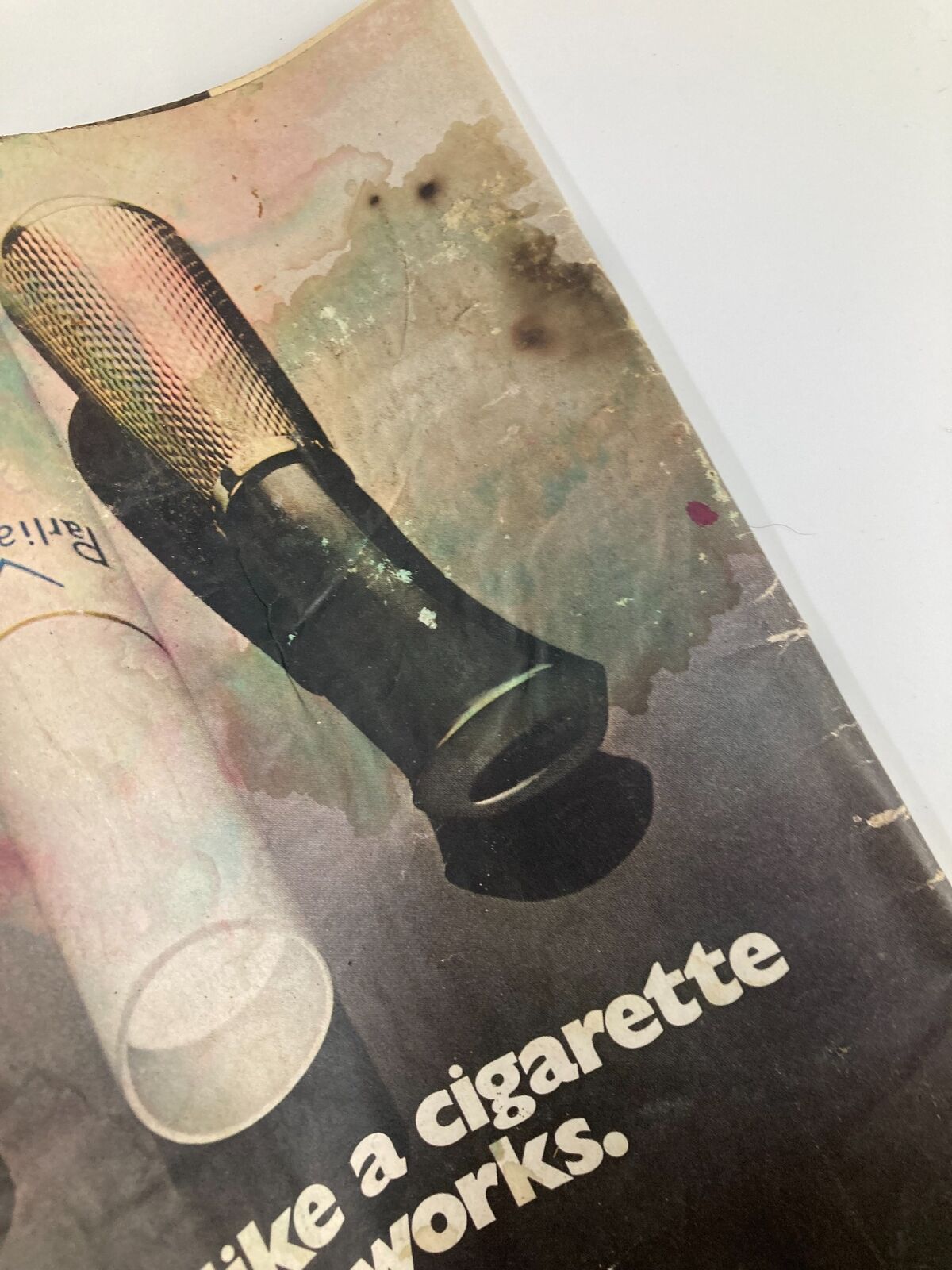 Detailed shot of a Parliament cigarette holder featured in the advertisement from VTG Life Magazine May 21 1971, showcasing wear and aesthetic appeal.