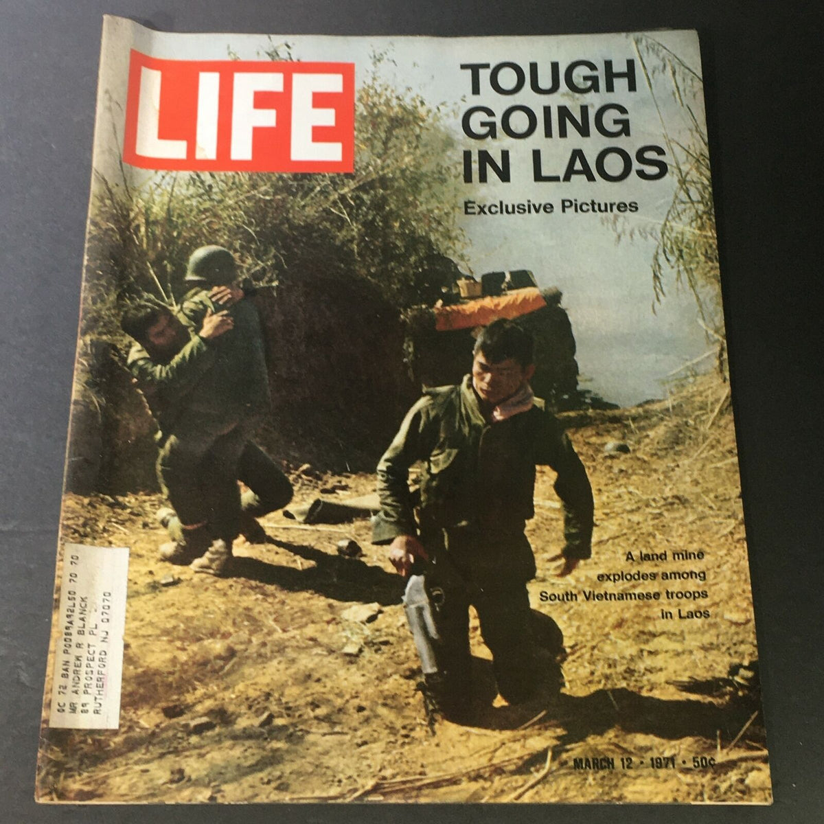 Vintage Life Magazine cover from March 12, 1971, depicting a landmine explosion impacting South Vietnamese troops, titled 'Tough Going in Laos' with exclusive pictures.