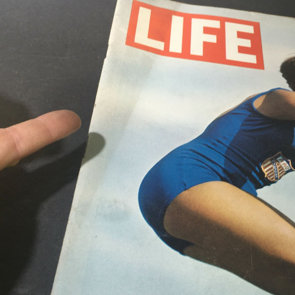 Detailed view of the title 'LIFE' on the cover of the VTG Life Magazine July 31, 1964, showcasing the magazine's vintage aesthetic related to women's Olympic sports.