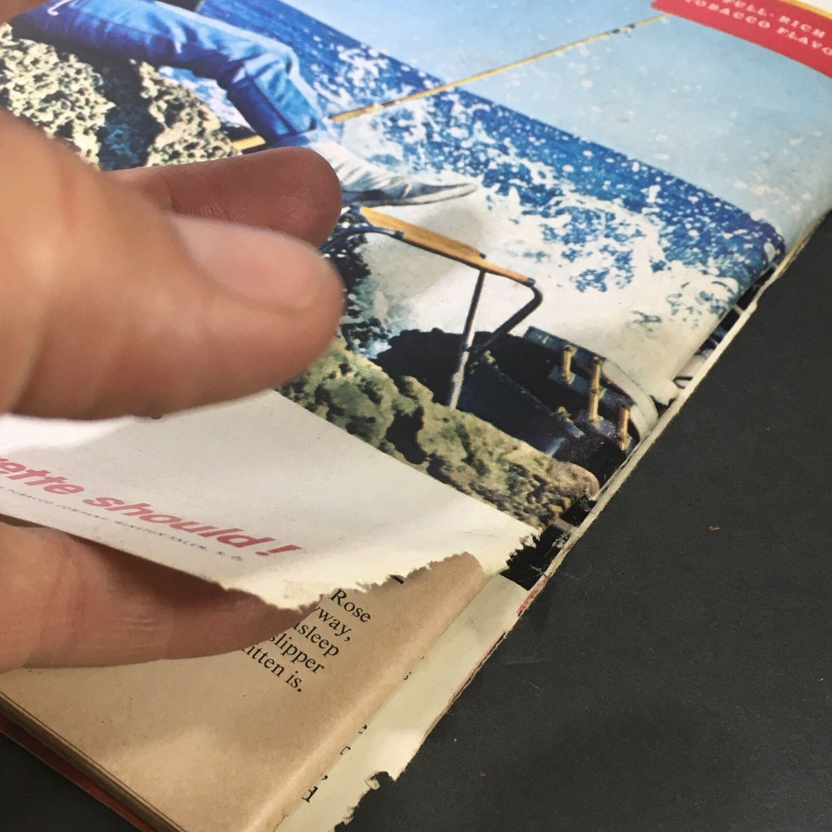 Close-up view of the vintage Life Magazine from October 1, 1965, showing a page with noticeable wear and tear, including ripped edges. This edition features articles about Alaska, the 49th state, highlighting its risks and promises.