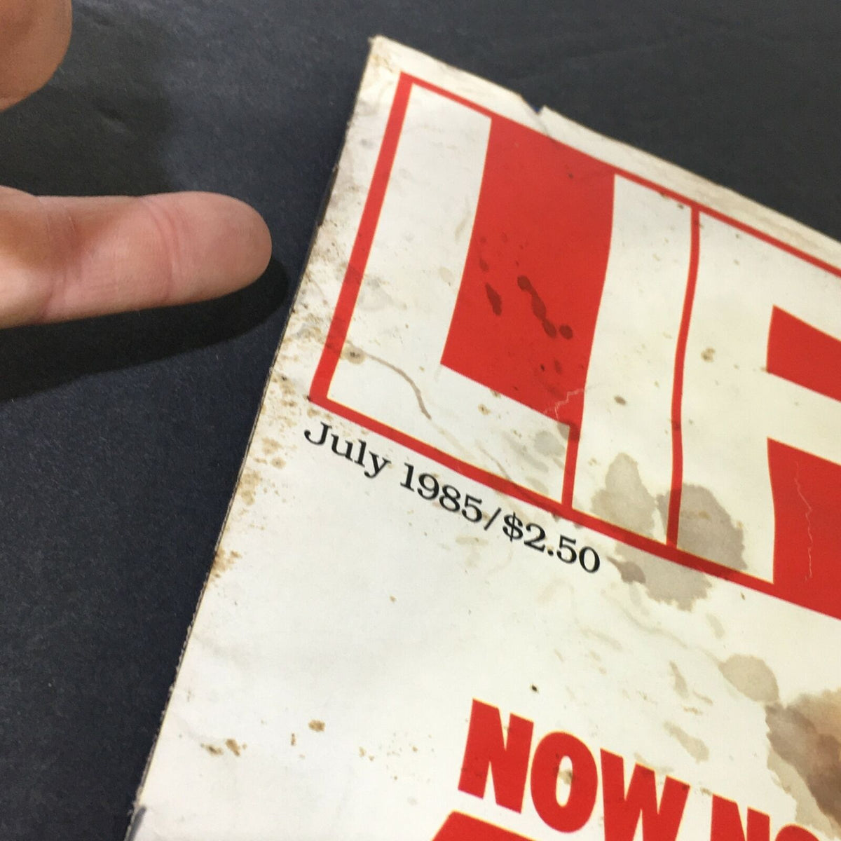 Detailed view of the top corner of VTG Life Magazine July 1985, showing the title 'LIFE', date, and signs of wear, emphasizing the magazine's historical significance.