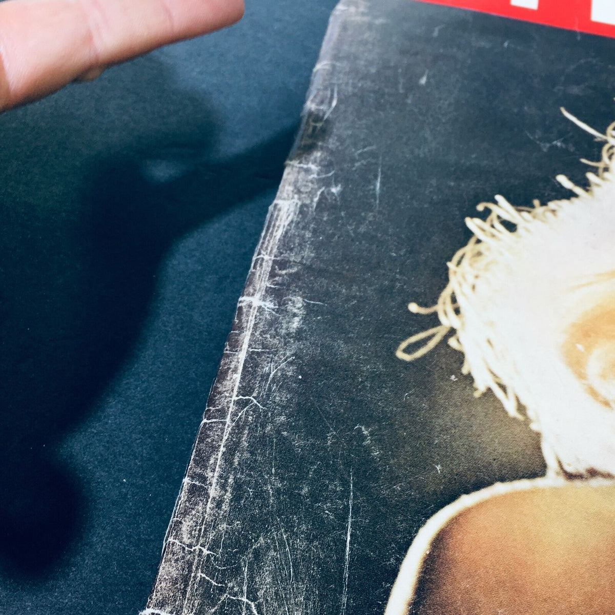 Close-up of the spine of 'VTG Life Magazine November 28 1960 - Carroll Baker Baby Doll Grows Up', showing wear and tear consistent with age.