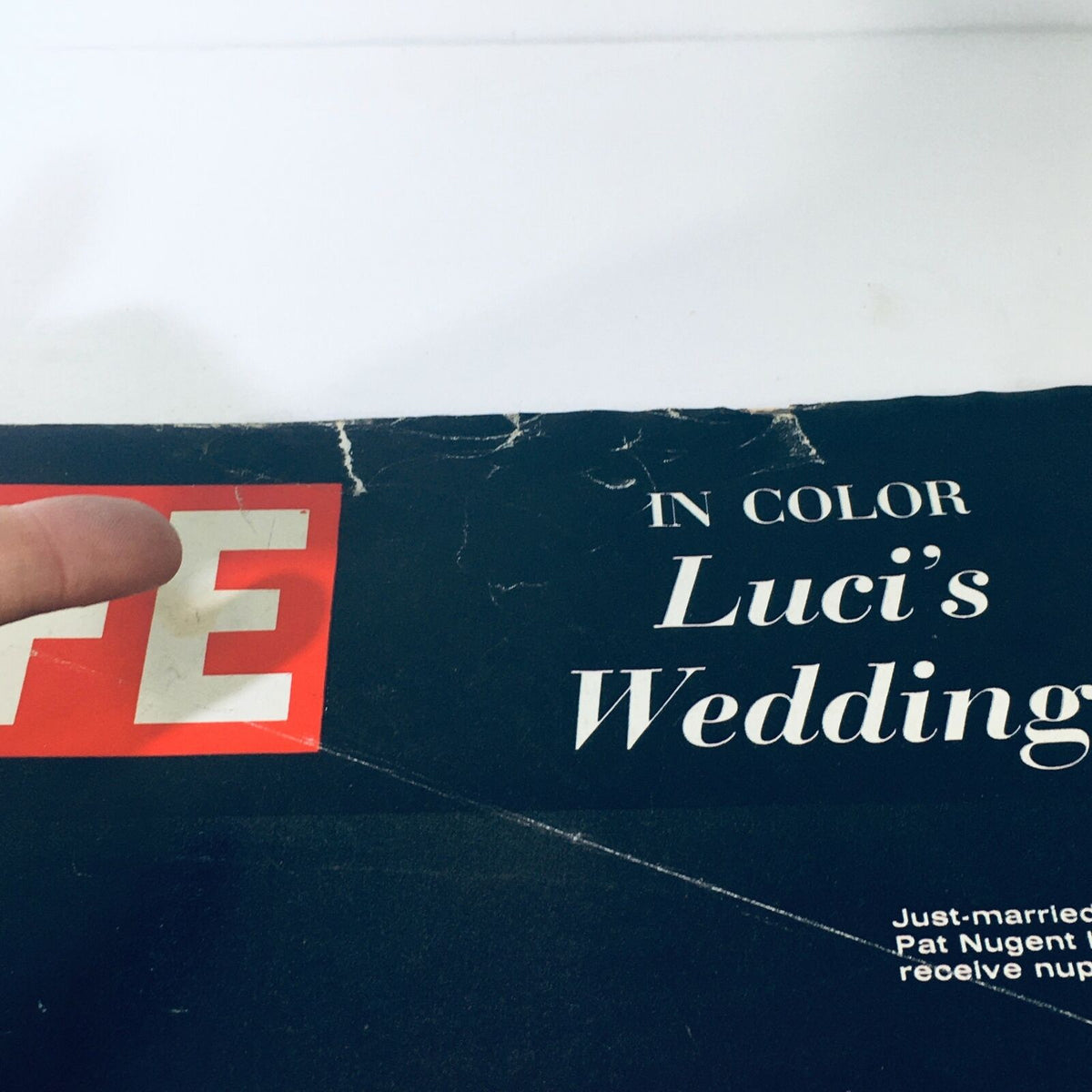 Close-up of the top left corner of the cover of VTG Life Magazine August 19 1966, showing the title and details of Luci Baines Johnson's wedding with visible signs of age.