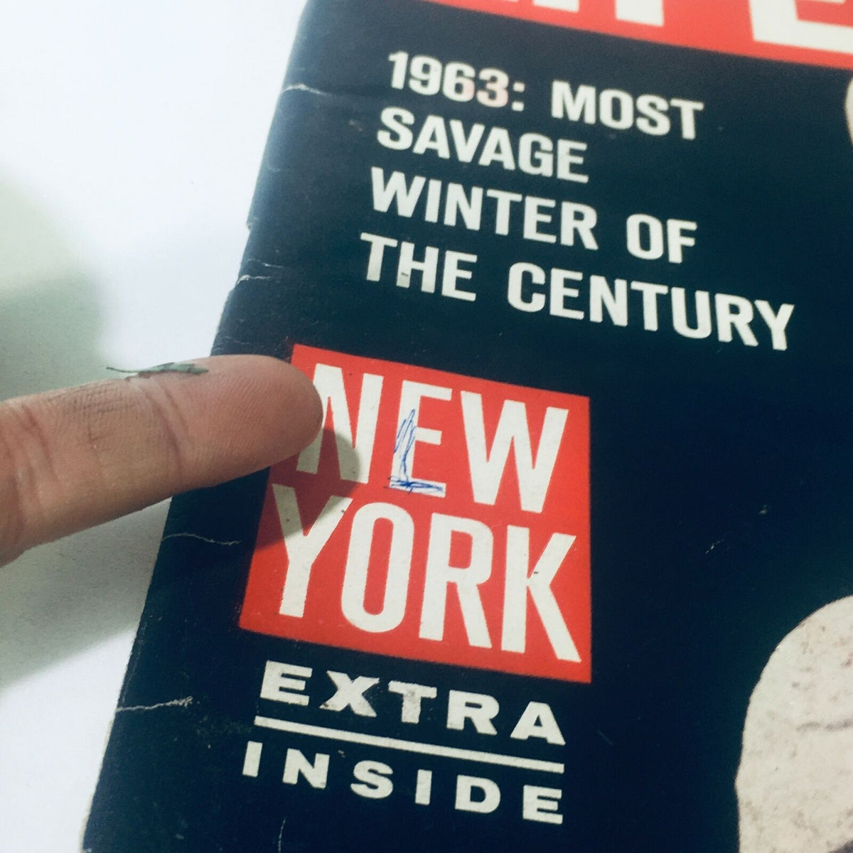 Close-up of the cover of VTG Life Magazine from February 8, 1963, highlighting the word 'NEW YORK' and the phrase '1963: Most Savage Winter of the Century' with a finger pointing at the title.