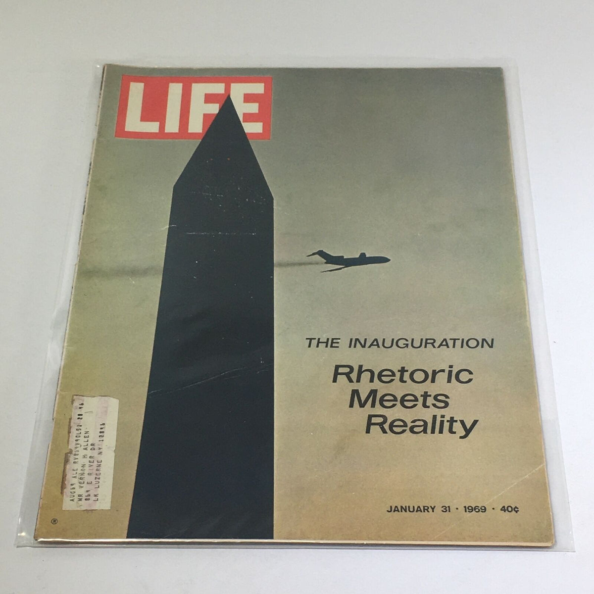 VTG Life Magazine cover from January 31, 1969, featuring the title 'The Inauguration: Rhetoric Meets Reality', showcasing a silhouette of a monument and an airplane, encapsulating a pivotal moment in American history.