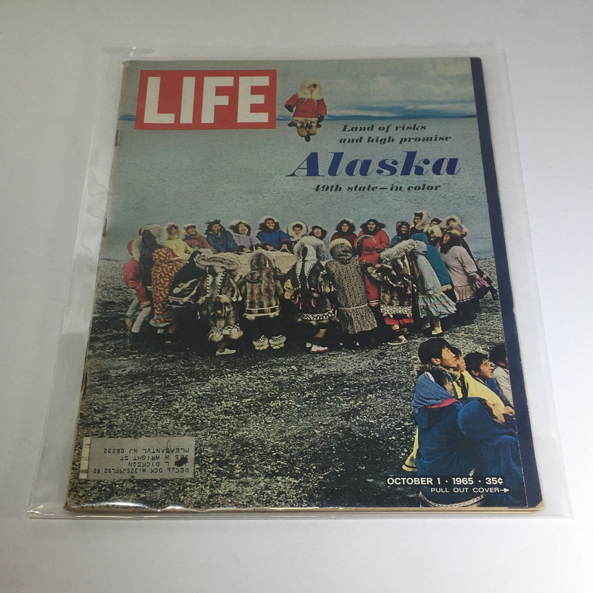 VTG Life Magazine - October 1, 1965 cover featuring Alaska, the 49th state. The cover displays a group of people in traditional attire gathered on a rocky shore, embodying the theme 'Land of Risks and Promise'.
