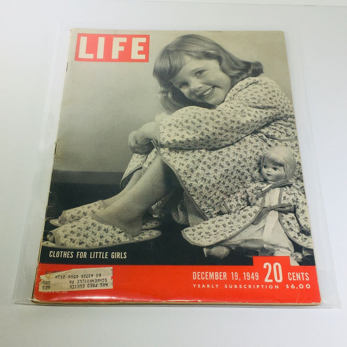 Cover of VTG Life Magazine from December 19, 1949, featuring a smiling little girl in a floral dress, showcasing clothes for little girls and holiday themes.