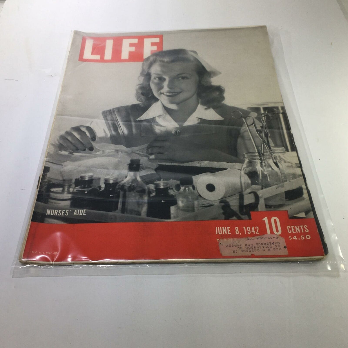 Cover of VTG Life Magazine from June 8, 1942, featuring Nurses' Aide with a woman smiling at a table filled with medical supplies. This vintage magazine highlights the dedication of nurses during World War II.