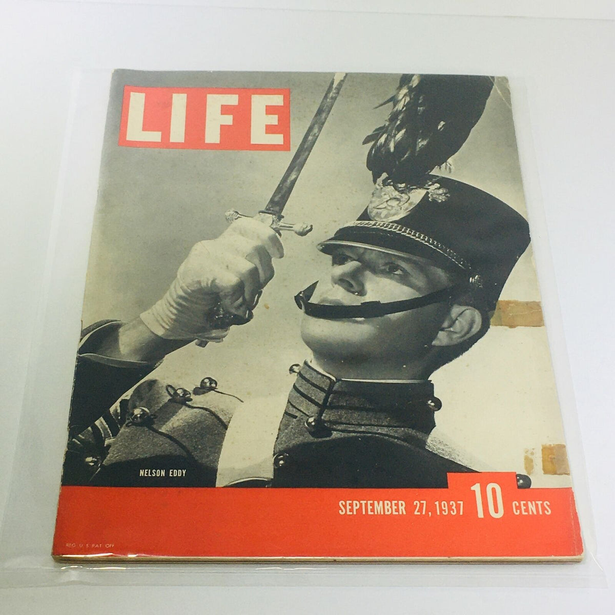 Cover of Vintage Life Magazine: September 27 1937 featuring Nelson Eddy in military attire, sword drawn, highlighting vintage design.