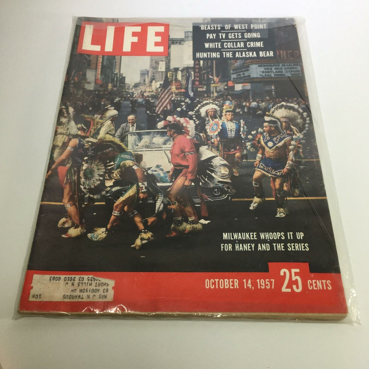 Life Magazine cover from October 14, 1957, featuring Milwaukee's vibrant celebration for Haney and the Series, showcasing participants in festive attire and a parade atmosphere.