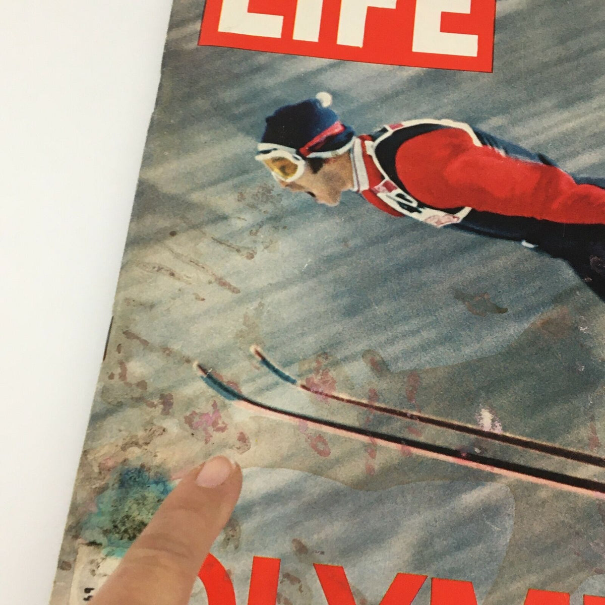 Close-up of the cover of VTG Life Magazine February 18 1972, showing details around the title 'OLYMPICS' and the image of Japanese Olympic Athlete Yukio Kasaya, highlighting wear and features of the magazine.