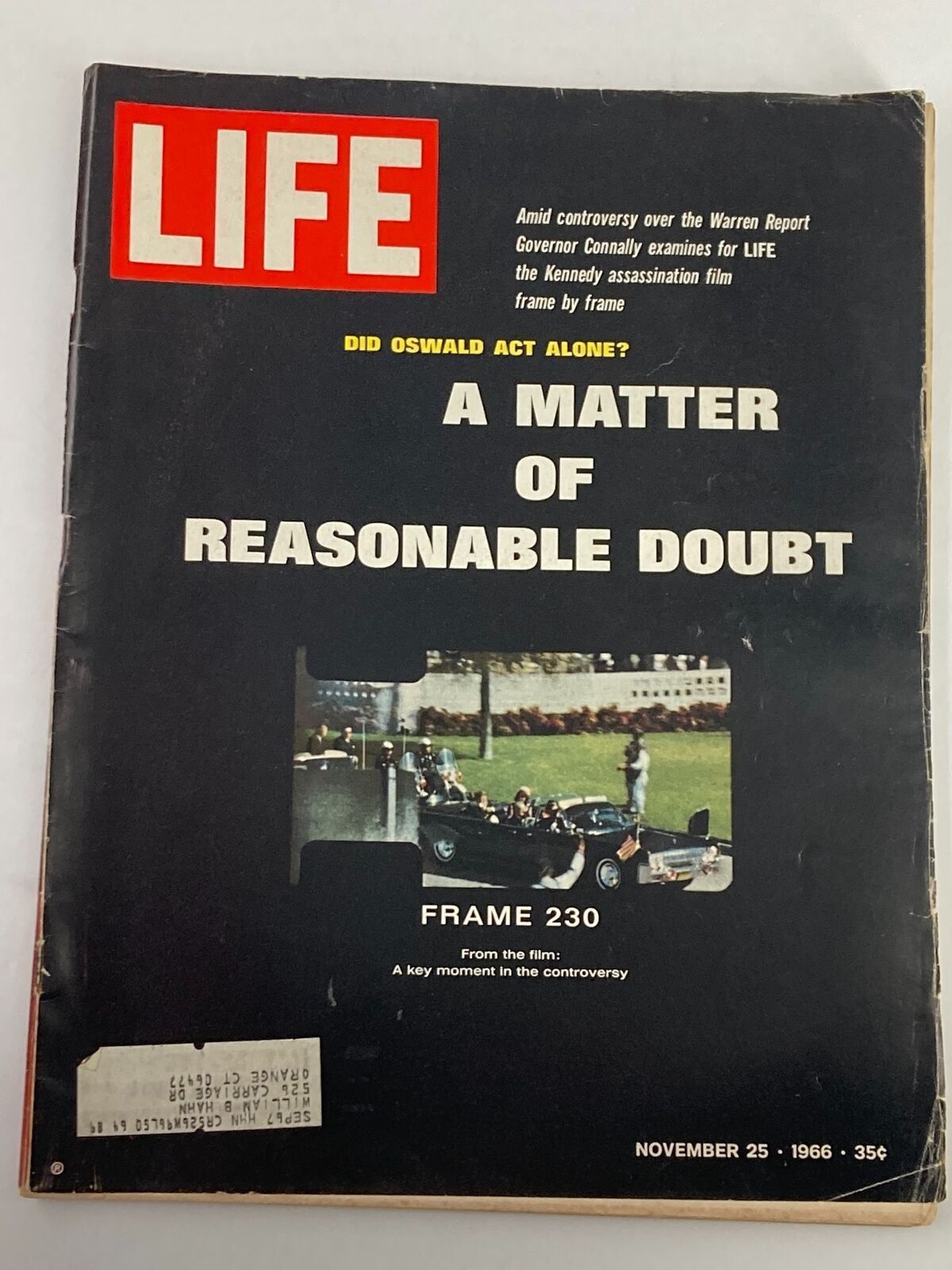 Vintage Life Magazine November 25, 1966 featuring the cover story 'A Matter of Reasonable Doubt' with a photograph related to the Kennedy assassination film. Condition shows signs of wear including an address label on the front cover.