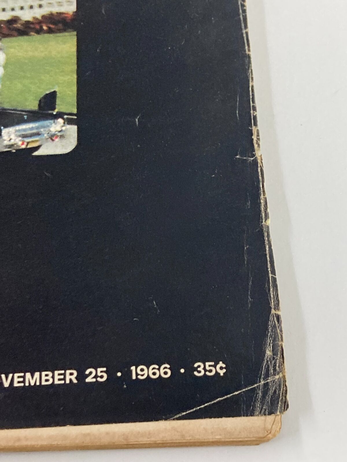 Close-up of the edge of the Vintage Life Magazine from November 25, 1966, detailing the publication date and price, along with visible creases, highlighting its vintage condition.