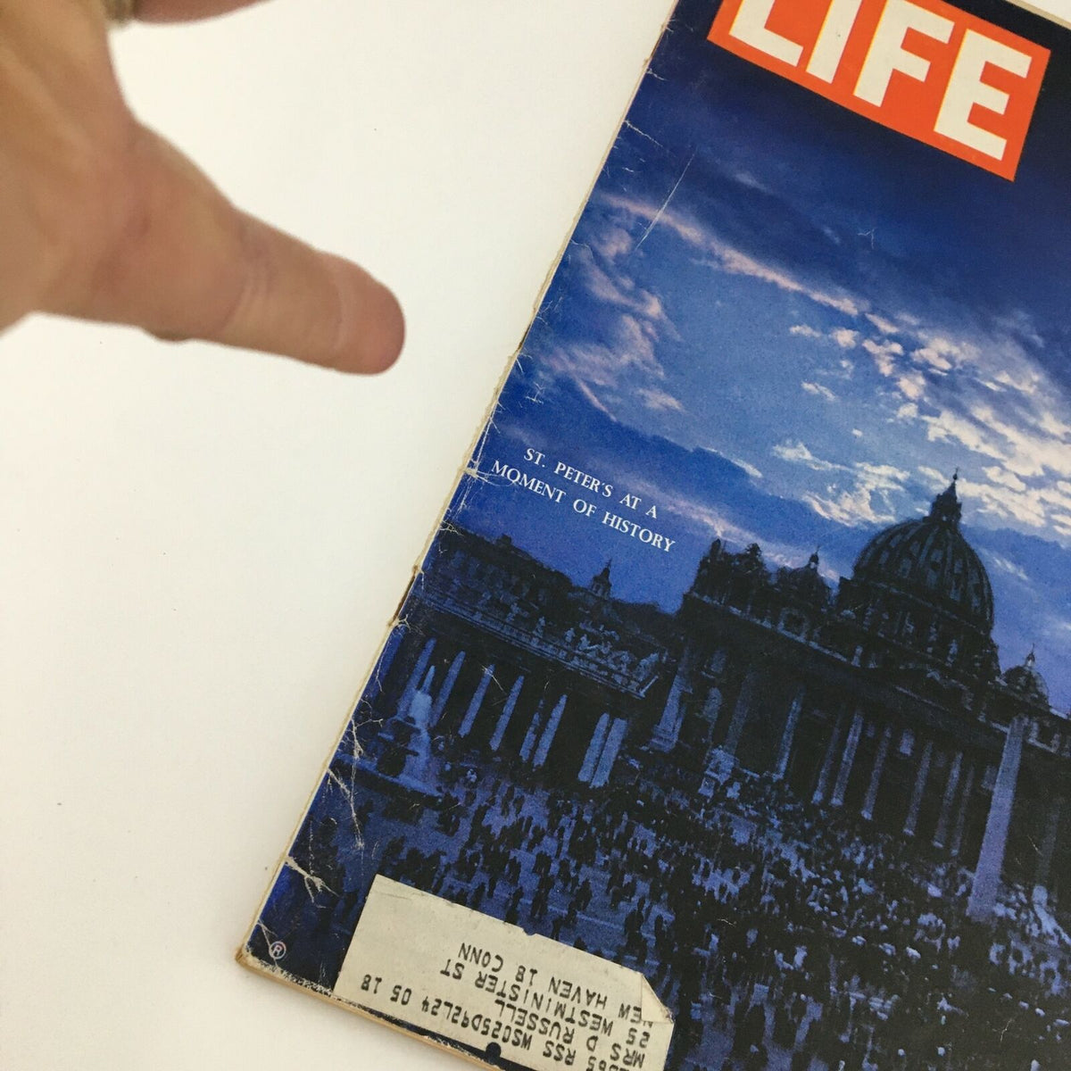 Vintage Life Magazine cover from June 14, 1963, featuring the title 'St. Peter's at a Moment of History.' The image showcases the magazine's distinct layout, including the iconic red 'LIFE' logo and a captivating photograph of St. Peter's Basilica, surrounded by a crowd, highlighting a significant historical moment.
