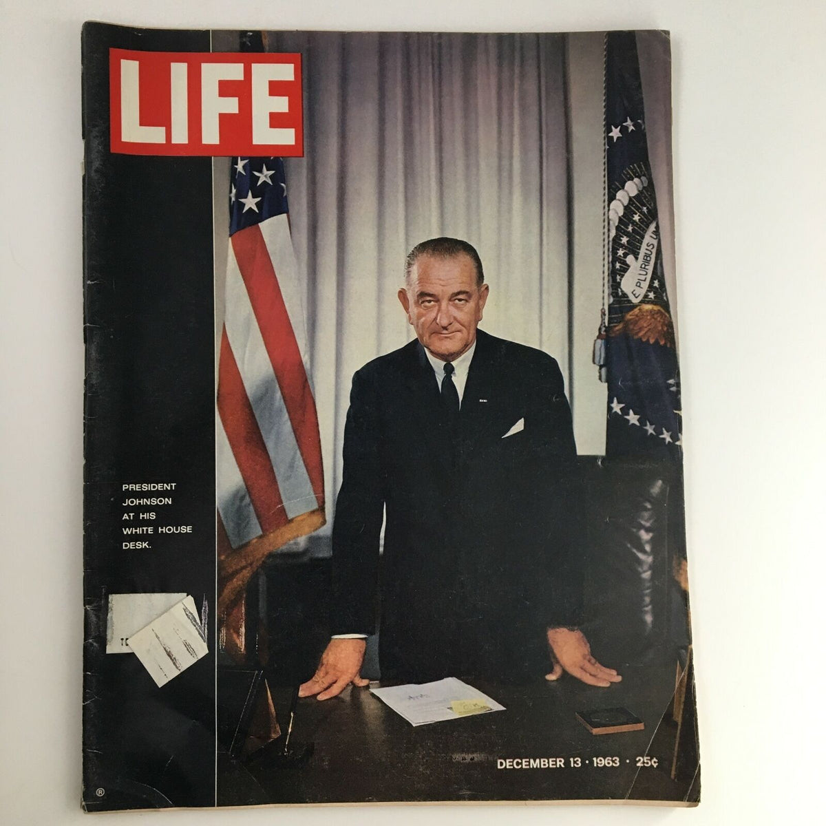 Cover of Life Magazine from December 13, 1963, featuring President Lyndon B. Johnson at his desk in the White House. The image captures a pivotal moment in American history with the presidential seal and American flags in the background.