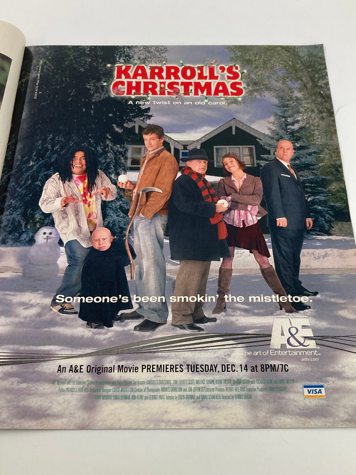 Advertisement for 'Karroll's Christmas,' an A&E original movie premiering December 14, featuring a group of characters in a snowy setting.