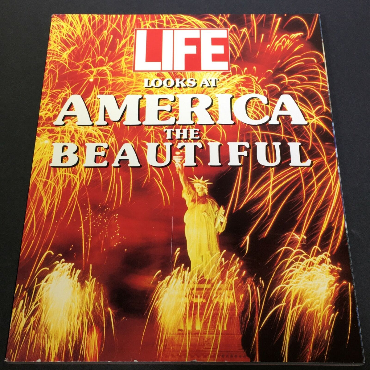 Cover of VTG Life 1990 The Time Inc. Magazine Company - Looks At America The Beautiful, featuring the Statue of Liberty with vibrant fireworks.