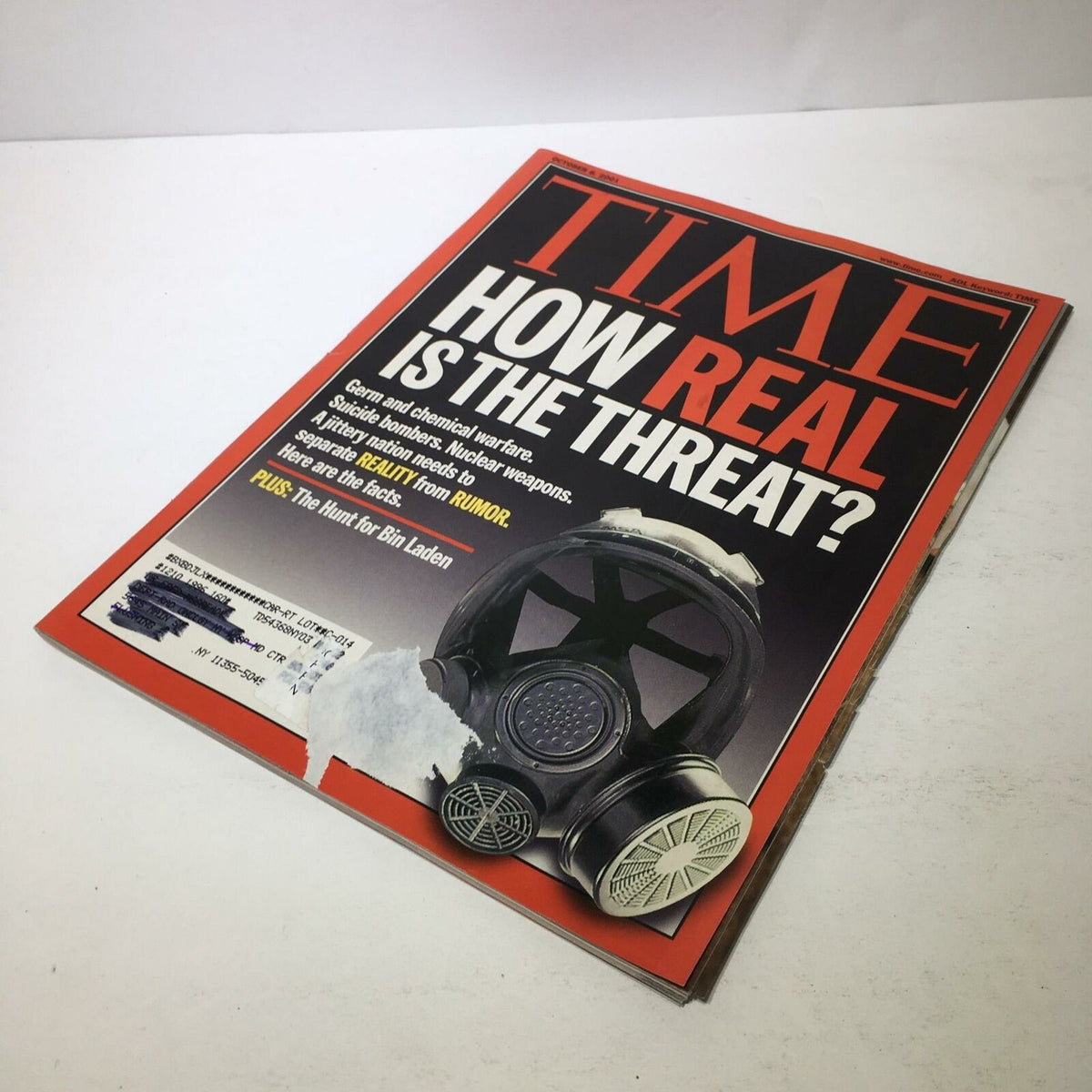Cover of Time Magazine, Oct 8 2001 issue titled 'How Real Is The Threat? Germ & Chemical Warfare', featuring a gas mask and a label indicative of patient preservation.