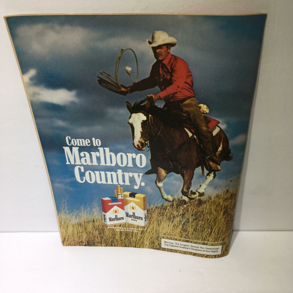 Ad from Time Magazine March 12, 1984 titled 'Now It's A Race', depicting a cowboy on horseback promoting Marlboro Country.