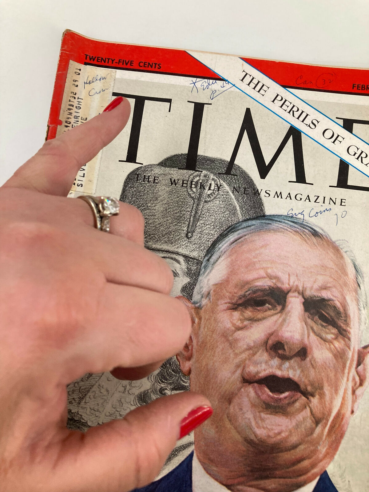Close-up of the vintage Time Magazine cover from February 8, 1963, showing Charles de Gaulle with handwritten notes, titled 'The Perils of Grandeur'.